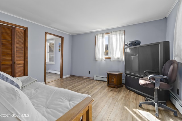 1176 State Highway 41, Afton, NY 13730 - bedroom featuring a baseboard radiator, wood finished floors, crown molding, and a closet