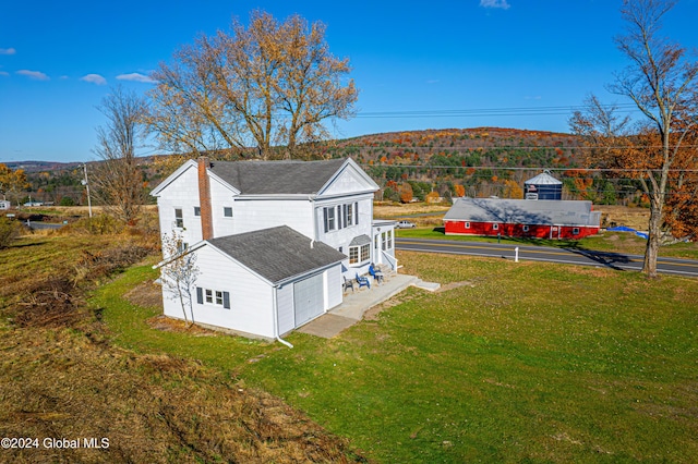 1176 State Highway 41, Afton, NY 13730 - view of home's exterior with roof with shingles, a garage, a chimney, and a lawn