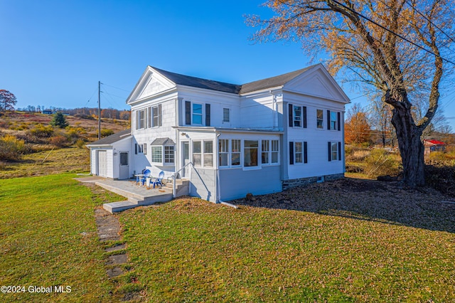 1176 State Highway 41, Afton, NY 13730 - rear view of property featuring a patio, a yard, an attached garage, and a sunroom