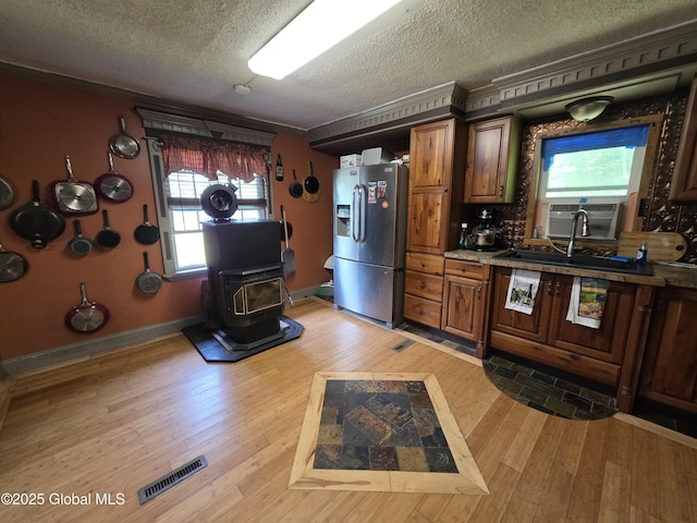 3841 State Highway 30, Mayfield, NY 12010 - kitchen with stainless steel fridge with ice dispenser, a textured ceiling, plenty of natural light, light wood finished floors, and ornamental molding