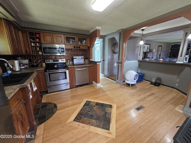 3841 State Highway 30, Mayfield, NY 12010 - kitchen featuring stainless steel appliances, open shelves, a sink, a textured ceiling, and light wood finished floors