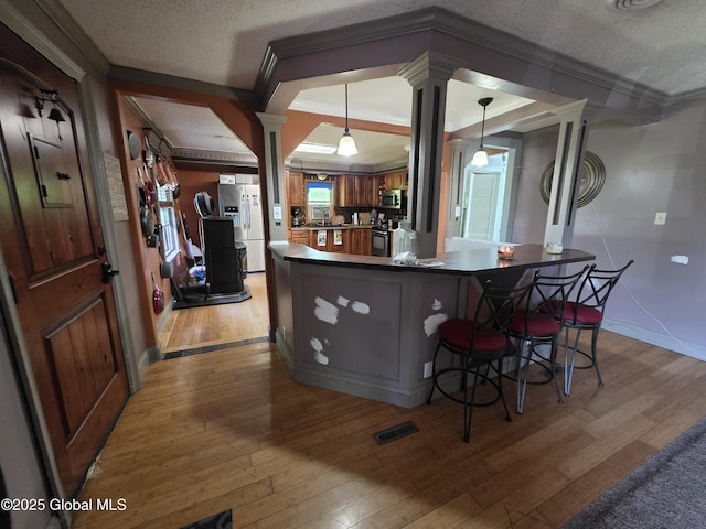 3841 State Highway 30, Mayfield, NY 12010 - kitchen with ornate columns, ornamental molding, light wood-style flooring, stainless steel appliances, and baseboards