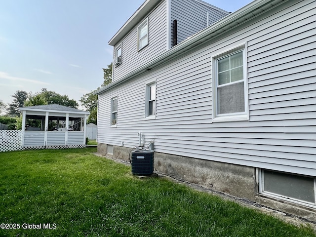 2803 Wellington Ave, Rotterdam, NY 12306 - view of home's exterior featuring central AC unit and a lawn