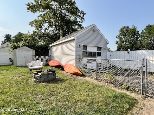 2803 Wellington Ave, Rotterdam, NY 12306 - rear view of house featuring a detached garage and an outdoor fire pit