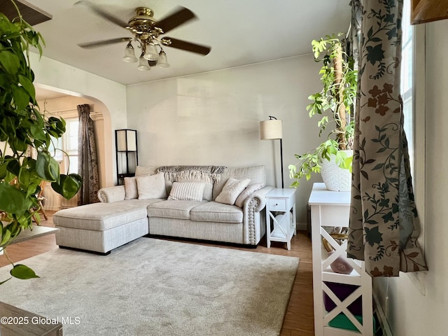 2803 Wellington Ave, Rotterdam, NY 12306 - living area featuring a ceiling fan, wood finished floors, and arched walkways
