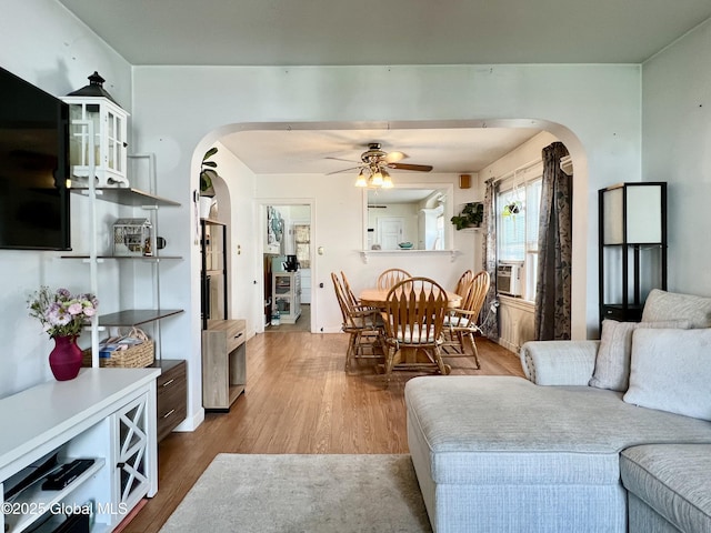 2803 Wellington Ave, Rotterdam, NY 12306 - living area with arched walkways, wood finished floors, ceiling fan, and cooling unit