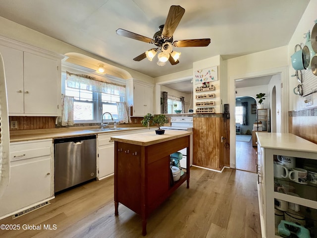 2803 Wellington Ave, Rotterdam, NY 12306 - kitchen with stainless steel dishwasher, white electric stove, a sink, arched walkways, and wood counters