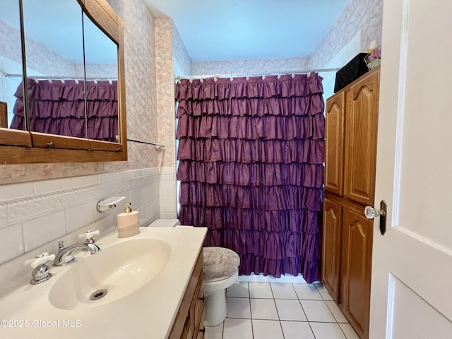 2803 Wellington Ave, Rotterdam, NY 12306 - full bath featuring toilet, tile walls, tile patterned floors, vanity, and a shower with shower curtain