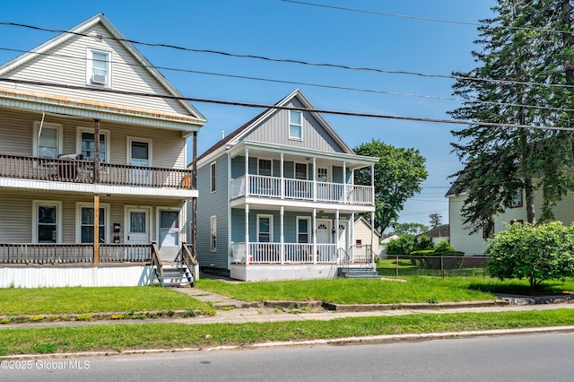 2420 Guilderland Ave, Schenectady, NY 12306 - view of front of property with covered porch, a balcony, and a front lawn
