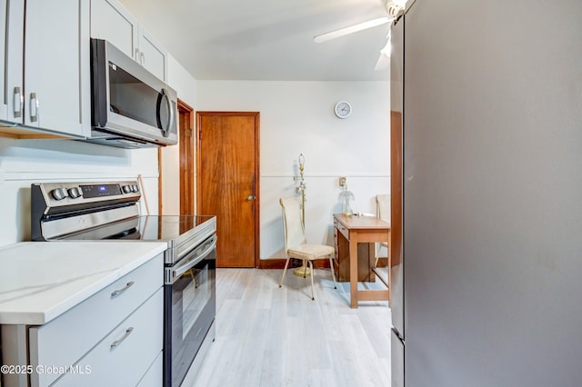 55 Crescent Ave, Amsterdam, NY 12010 - kitchen featuring appliances with stainless steel finishes, light wood-style flooring, and a ceiling fan
