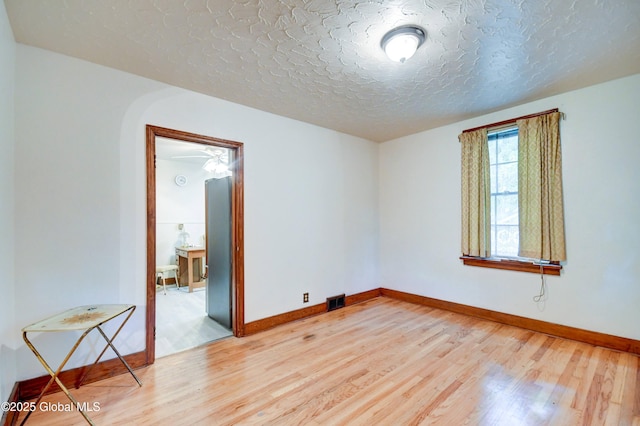 55 Crescent Ave, Amsterdam, NY 12010 - spare room with light wood-style floors, baseboards, and a textured ceiling
