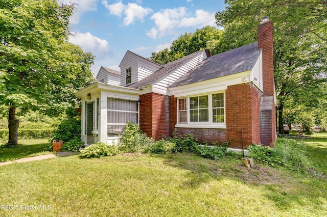 55 Crescent Ave, Amsterdam, NY 12010 - view of front facade with brick siding, a front yard, a chimney, and roof with shingles