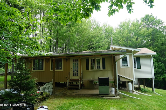 127 Fern Ln, Jefferson, NY 12093 - rear view of house with a yard and a patio area