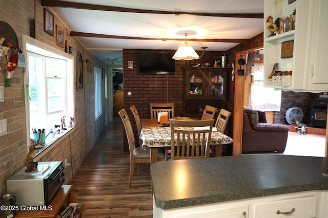 127 Fern Ln, Jefferson, NY 12093 - dining room featuring dark wood-style flooring, beamed ceiling, and brick wall