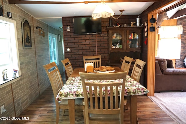 127 Fern Ln, Jefferson, NY 12093 - dining area with wood finished floors and brick wall