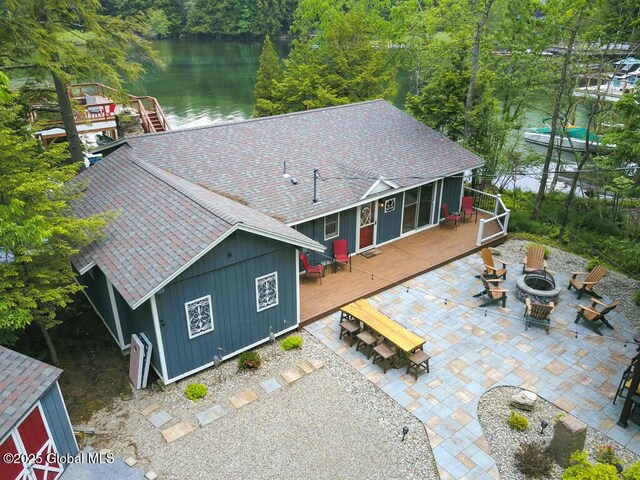 3602 Echo Bay Ln, Fort Ann, NY 12844 - rear view of property featuring a fire pit, a shingled roof, a deck with water view, and a patio