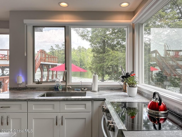3602 Echo Bay Ln, Fort Ann, NY 12844 - kitchen featuring electric stove, healthy amount of natural light, white cabinetry, and light stone countertops