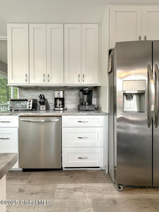 3602 Echo Bay Ln, Fort Ann, NY 12844 - kitchen with stainless steel appliances, white cabinetry, and light wood finished floors