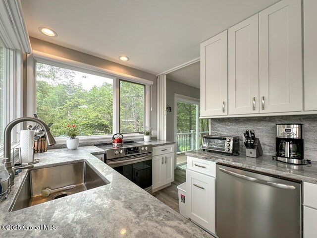 3602 Echo Bay Ln, Fort Ann, NY 12844 - kitchen with appliances with stainless steel finishes, light stone counters, white cabinets, and recessed lighting
