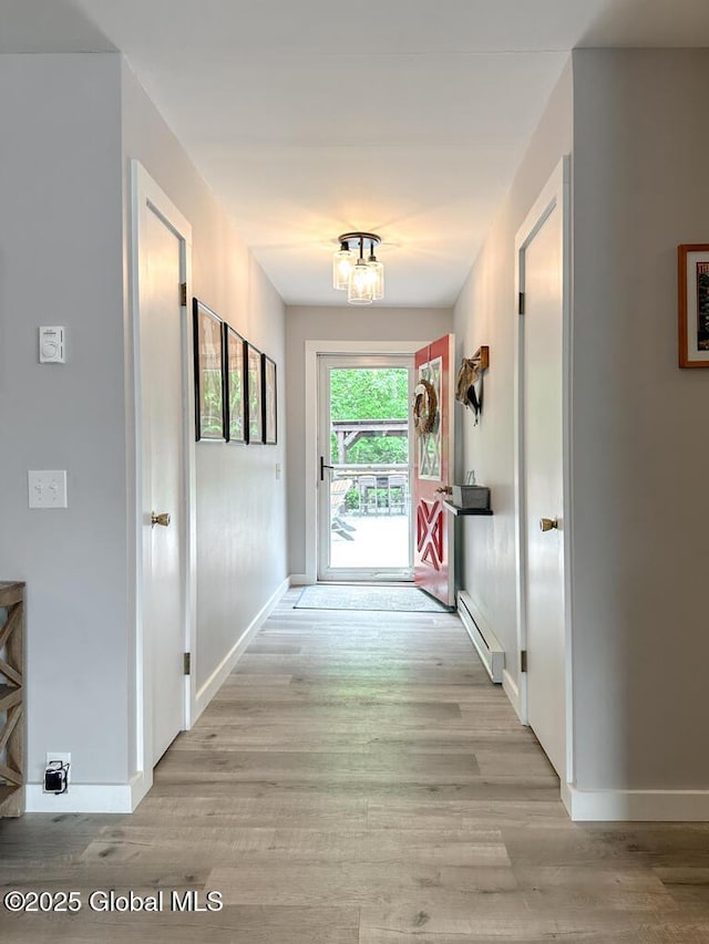 3602 Echo Bay Ln, Fort Ann, NY 12844 - hallway featuring a baseboard heating unit and light wood-style floors