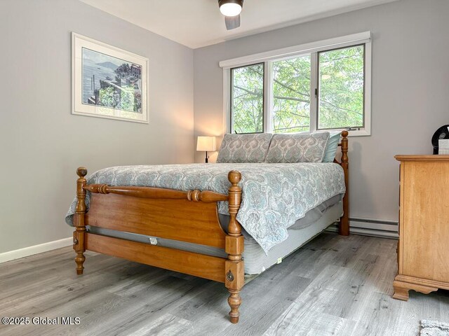 3602 Echo Bay Ln, Fort Ann, NY 12844 - bedroom with a baseboard heating unit, wood finished floors, and ceiling fan