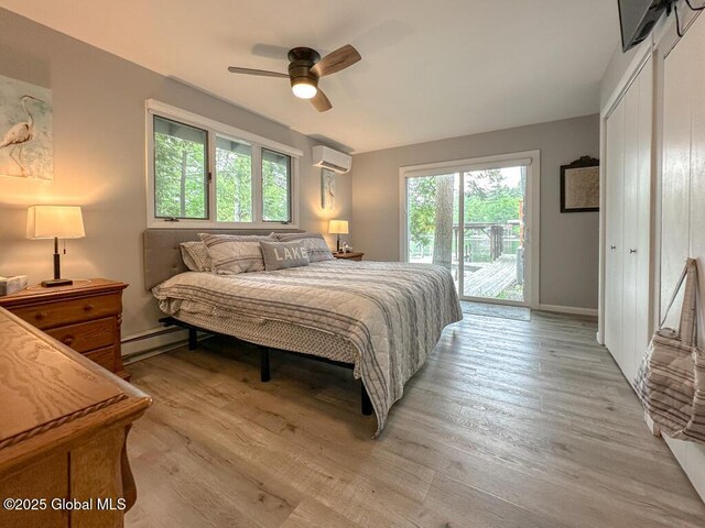 3602 Echo Bay Ln, Fort Ann, NY 12844 - bedroom featuring access to outside, a wall mounted air conditioner, a baseboard radiator, and light wood-style floors