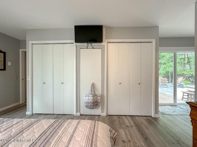 3602 Echo Bay Ln, Fort Ann, NY 12844 - bedroom featuring wood finished floors, multiple closets, and access to outside