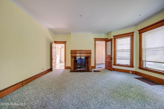 510 S William St, Johnstown, NY 12095 - unfurnished living room featuring ornamental molding, a fireplace with flush hearth, and carpet flooring