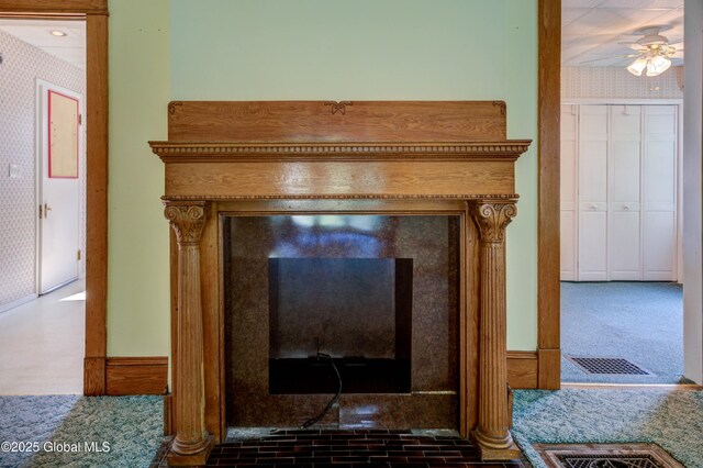 510 S William St, Johnstown, NY 12095 - detailed view of wallpapered walls, a ceiling fan, carpet floors, and a glass covered fireplace