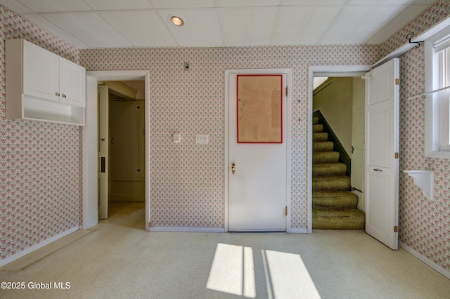 510 S William St, Johnstown, NY 12095 - spare room with wallpapered walls, stairway, light colored carpet, and recessed lighting