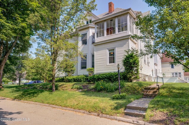 510 S William St, Johnstown, NY 12095 - view of front facade with a front lawn and a chimney
