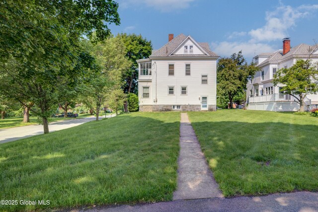 510 S William St, Johnstown, NY 12095 - view of front of property featuring a front yard and a chimney