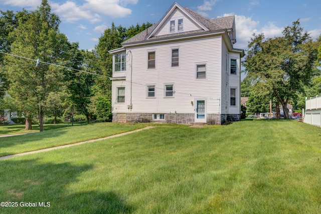 510 S William St, Johnstown, NY 12095 - view of side of property featuring a lawn and roof with shingles
