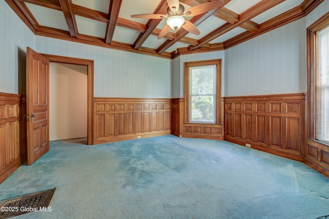 510 S William St, Johnstown, NY 12095 - carpeted empty room featuring coffered ceiling, wainscoting, beamed ceiling, plenty of natural light, and ceiling fan