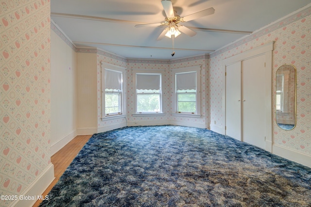 510 S William St, Johnstown, NY 12095 - empty room with wallpapered walls, ceiling fan, light wood finished floors, and ornamental molding