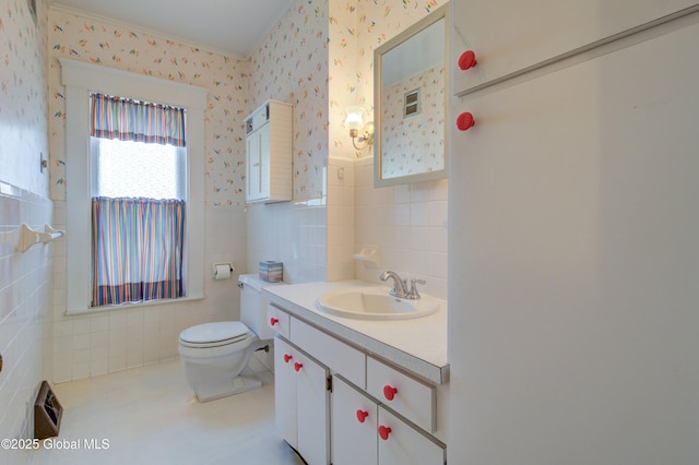 510 S William St, Johnstown, NY 12095 - bathroom with tile walls, wallpapered walls, vanity, wainscoting, and crown molding