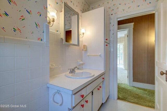 510 S William St, Johnstown, NY 12095 - bathroom with wallpapered walls, vanity, and a wainscoted wall