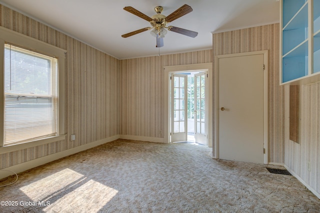 510 S William St, Johnstown, NY 12095 - carpeted spare room featuring wallpapered walls, ornamental molding, and a ceiling fan