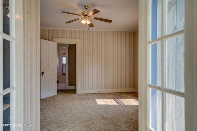 510 S William St, Johnstown, NY 12095 - spare room featuring carpet flooring, ornamental molding, wallpapered walls, and ceiling fan