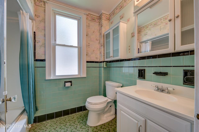 510 S William St, Johnstown, NY 12095 - full bath featuring wallpapered walls, wainscoting, vanity, tile walls, and shower / bath combination with curtain