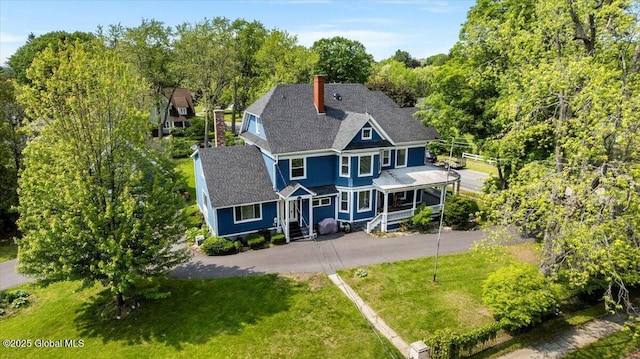 4 Van Dyke Ave, Amsterdam, NY 12010 - back of property featuring a chimney, a lawn, asphalt driveway, and roof with shingles