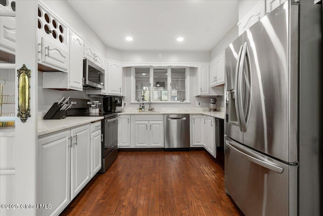 4 Van Dyke Ave, Amsterdam, NY 12010 - kitchen featuring appliances with stainless steel finishes, white cabinets, dark wood-type flooring, a sink, and recessed lighting