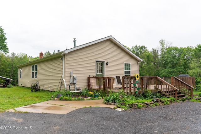 79 Chandler Ln, Greenfield, NY 12859 - rear view of property with a deck, a chimney, and a yard
