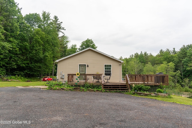 79 Chandler Ln, Greenfield, NY 12859 - view of front of property with a deck and a forest view