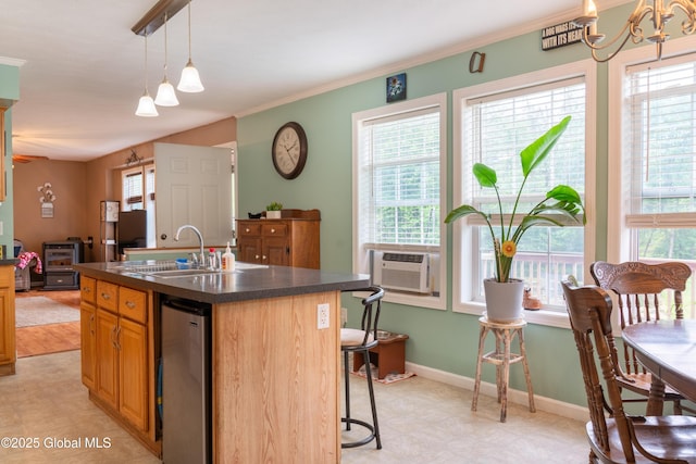 79 Chandler Ln, Greenfield, NY 12859 - kitchen with dark countertops, a chandelier, a kitchen breakfast bar, a center island with sink, and fridge