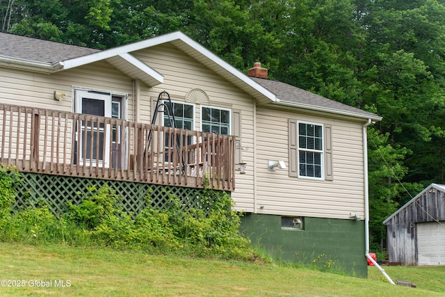 79 Chandler Ln, Greenfield, NY 12859 - view of front of house with a deck, a detached garage, a chimney, an outdoor structure, and roof with shingles
