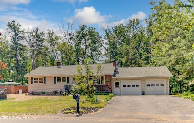 8 Birchtree Ln, Milton, NY 12020 - ranch-style house with a chimney, an attached garage, and driveway