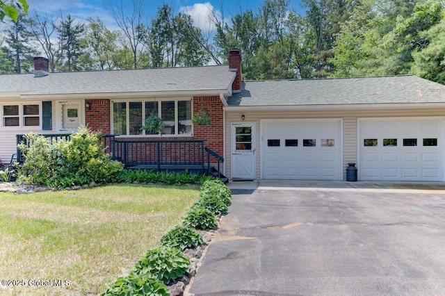 8 Birchtree Ln, Milton, NY 12020 - single story home featuring a chimney, asphalt driveway, an attached garage, brick siding, and a front yard