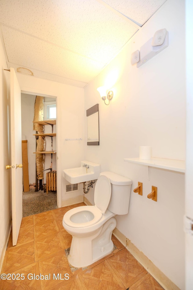 1374 10th Ave, Schenectady, NY 12303 - half bath featuring toilet, a sink, and baseboards