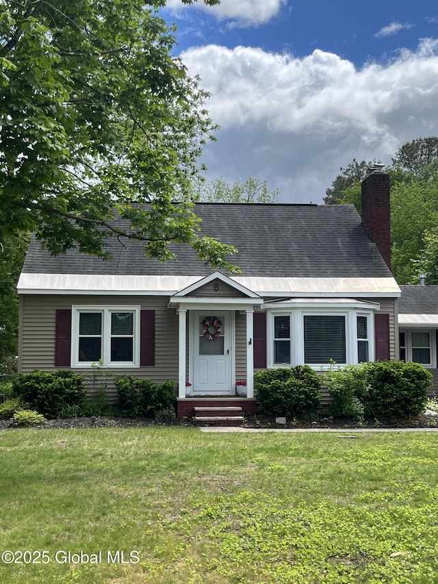 6 Pine Rd, Moreau, NY 12803 - view of front of house featuring a front lawn and a chimney